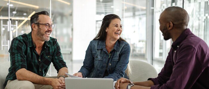 Group of three working and smiling