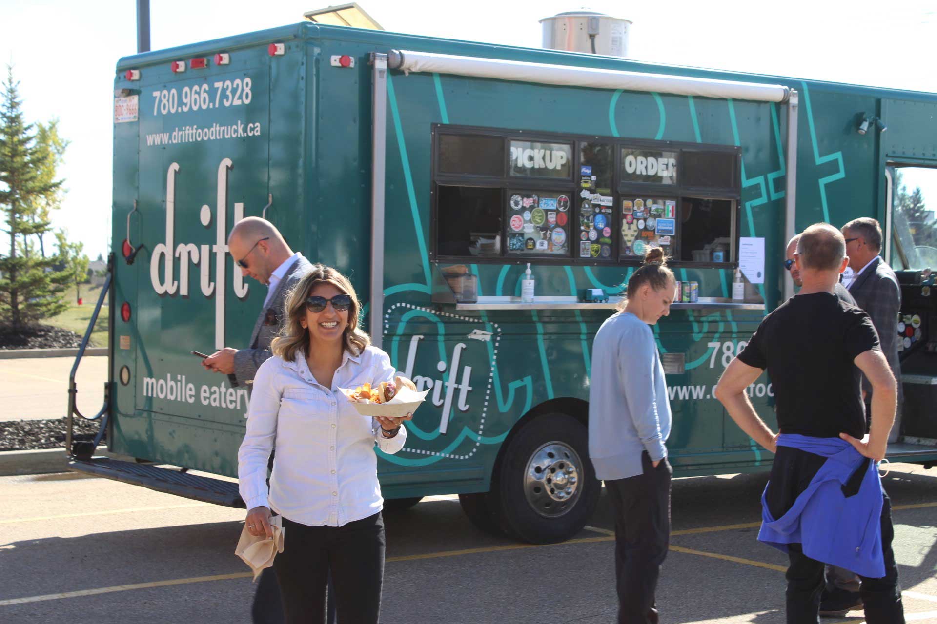 Azaali grabs a bite from a food truck at a summer event